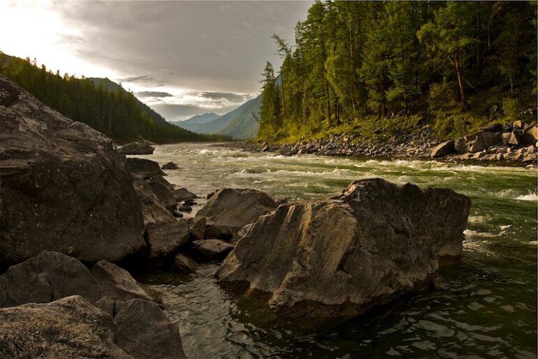 Snake River flows through rocky valley with clouds overhead