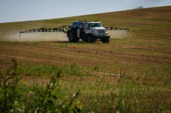Truck in farm field spraying pesticide