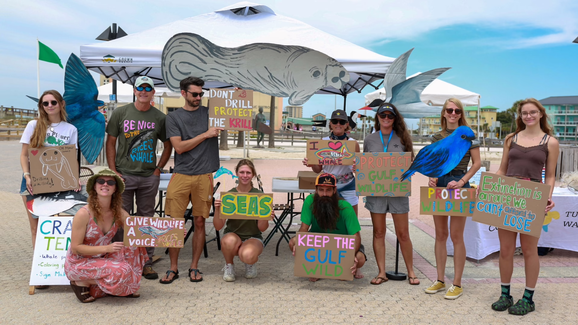 Community volunteers gather on the beach after a cleanup event to support coastal wildlife, clean shores, and healthy marine habitats.